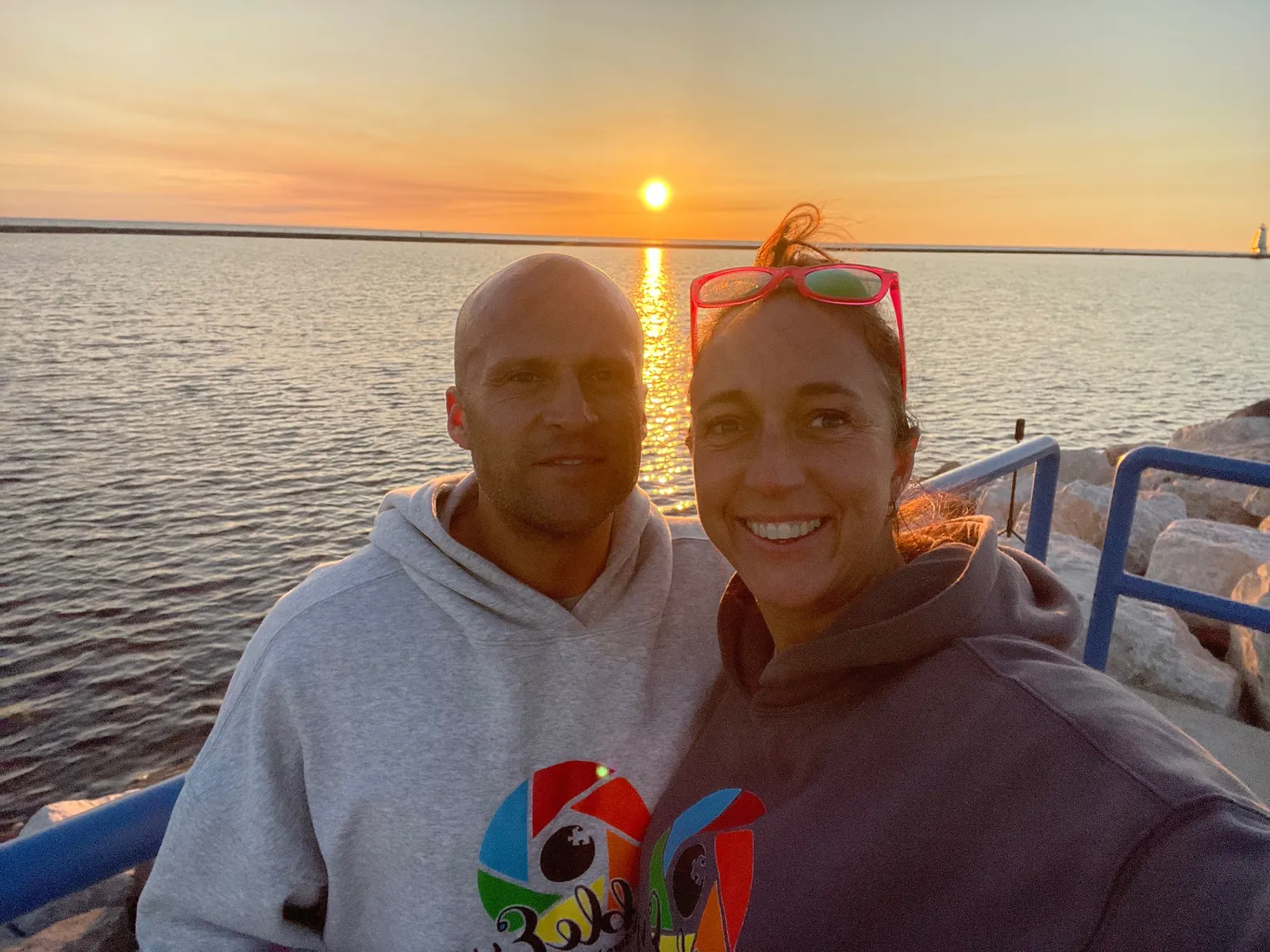 Two people together at a Lake Michigan sunset in Ludington.